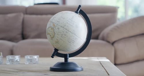 Rotation around a terrestrial globe placed on a living room table