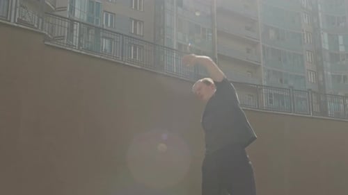 Sportive Guy Doing Side Bends in Street