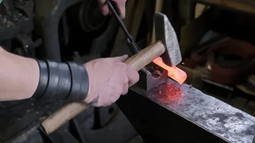 Blacksmith Hands Hammering Hot Glowing Steel on Anvil Closeup Traditional Metal Forging Workshop