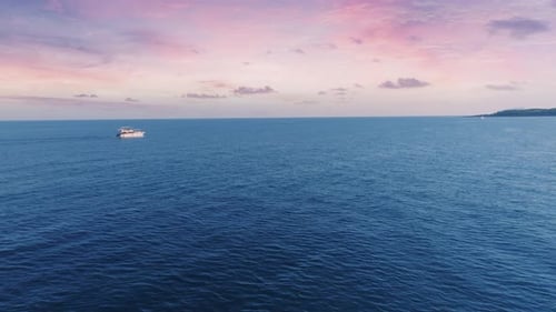 The Yacht Sails on the Sea at Sunset