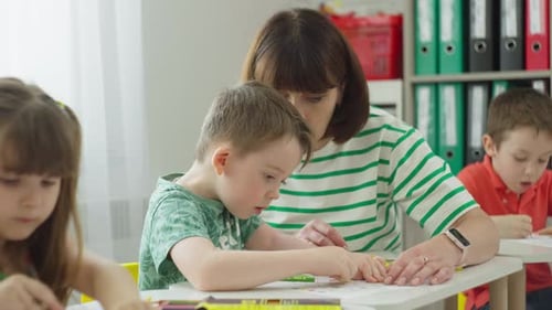 Teacher Assisting Children with Coloring Activity in Classroom