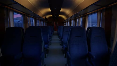 Train with empty seats. Interior view of train with blue upholstered seats.