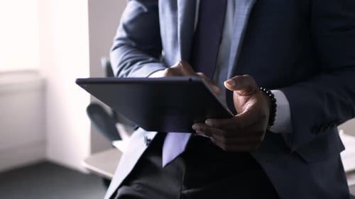 African american businessman focused on digital tablet in office building