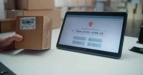 Inventory Manager Scans Code on Parcel Tablet Shows Delivery Tracking System for Monitoring Package