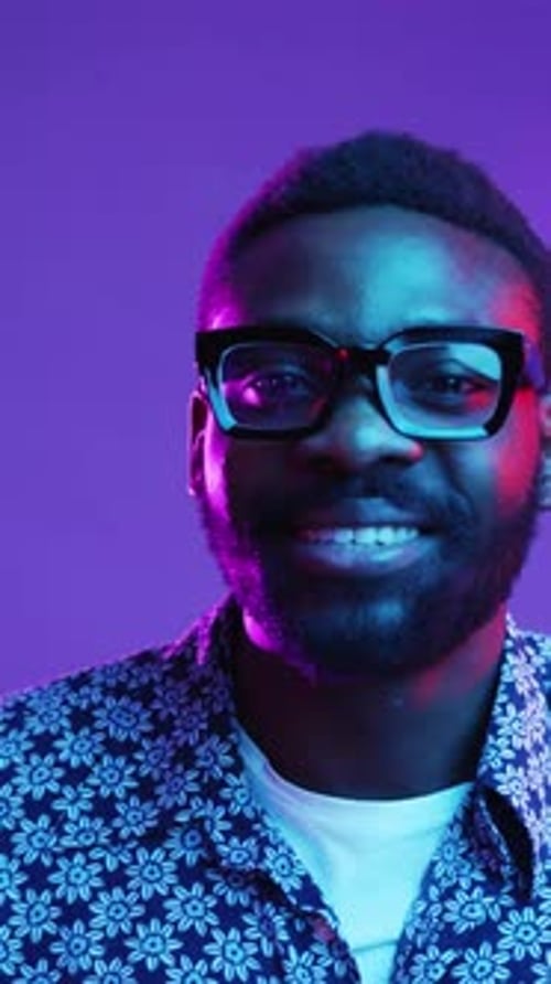 A Stylish and Engaging Portrait Featuring Dramatic Lighting and Trendy Sunglasses