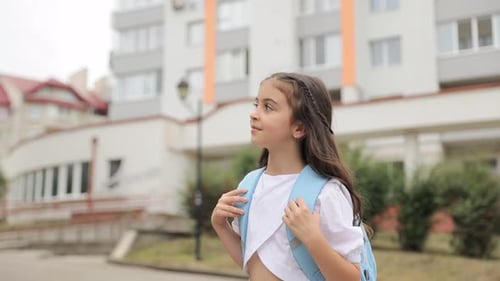Little Girl Carrying Backpacks Going Running to School Education Concept