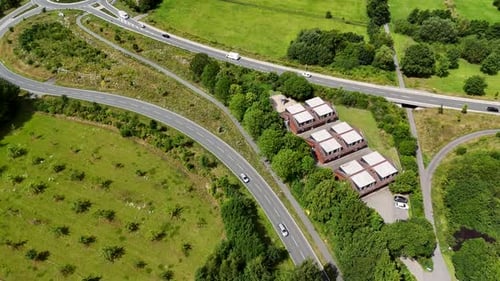 New Build roundabout and interstate roads in rural area of America. Sunny day with green grass field