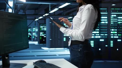 Woman Works on Tablet in Data Center