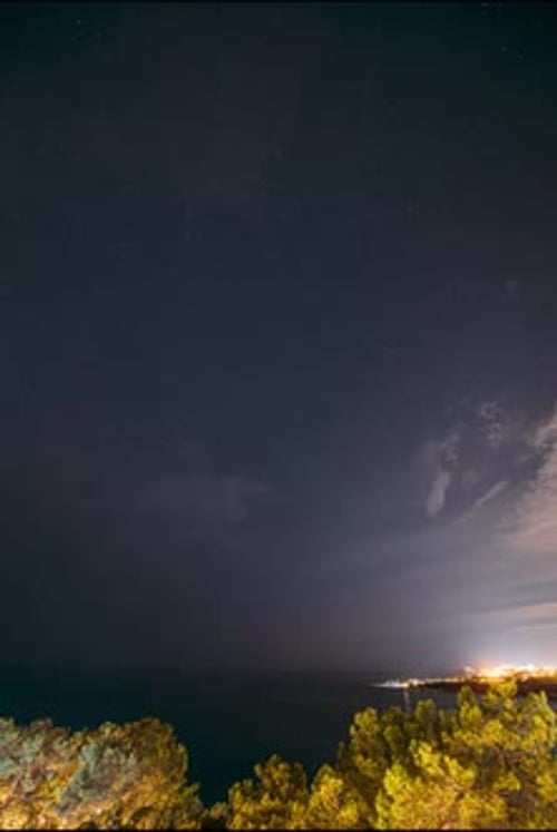 Night Sky Timelapse Over Ocean and City