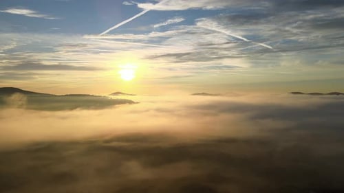 Golden Sunrise Above Foggy Landscape