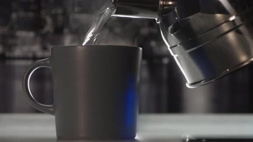 Steaming Water Poured into Mug from Kettle Close Up