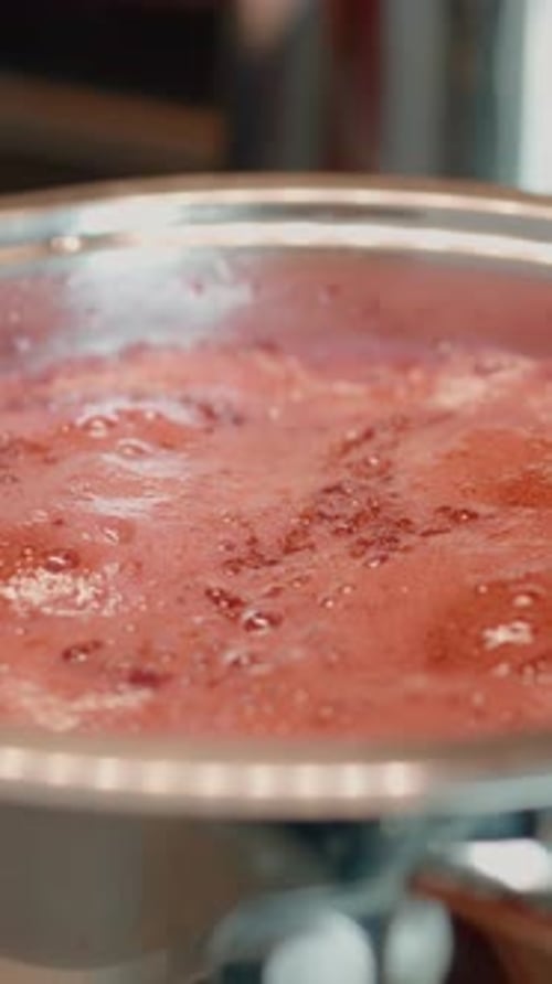 Red Sauce Simmering in Stainless Steel Pan