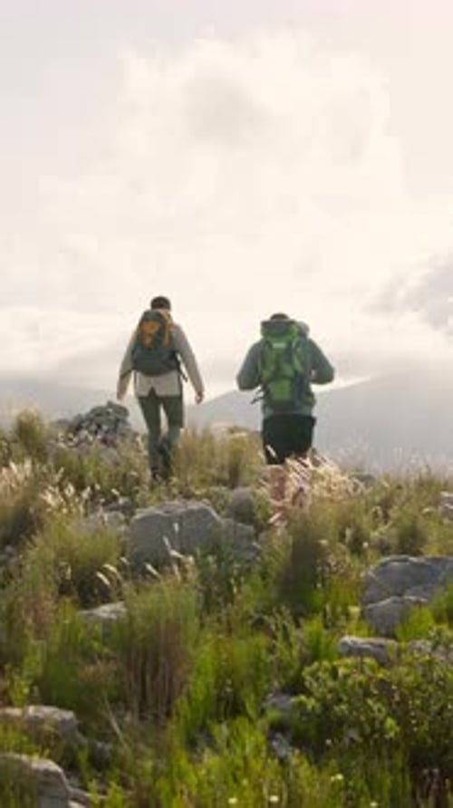 Back, couple and hiking on mountain for adventure date, tourist exploration and bonding together