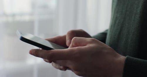 Hands Typing on Phone Indoors Close Up