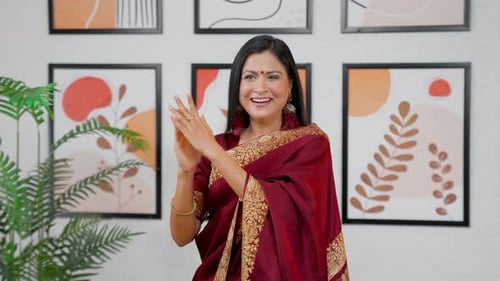 Cheerful Woman Clapping Hands in Appreciation Indoors