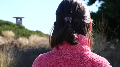 Brother and sister walking together on a path. Slow-motion gimbal shot.