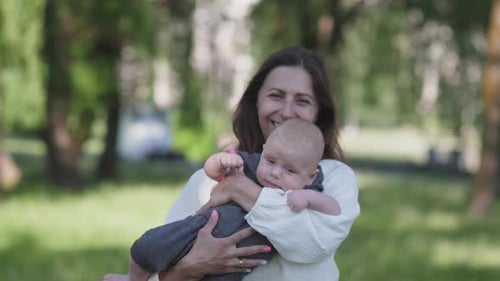 Mother and Baby Laughing in a Park