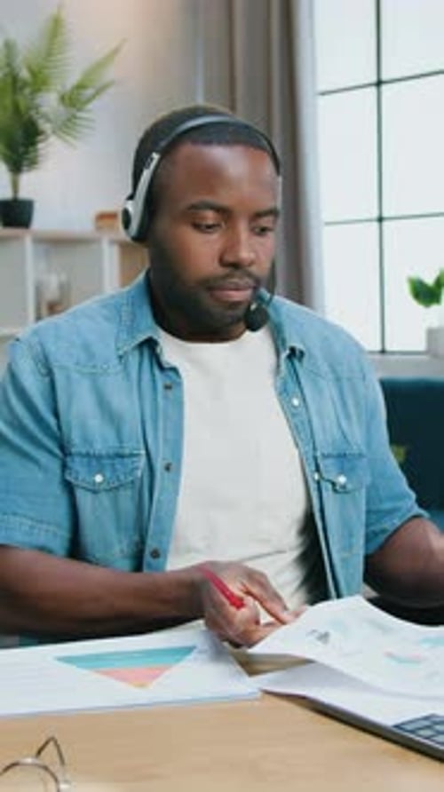 Man Presenting Data on Video Call from Home