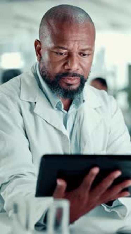 Man, scientist and research with tablet at laboratory for experiment results or medical tests