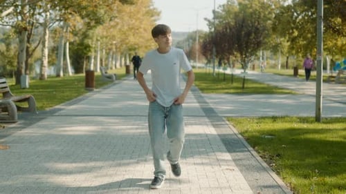 Adolescent Life in Motion Walking Through a Sunny Park