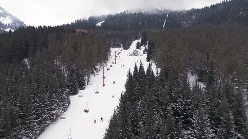 Aerial view of skiing people and gondola lift in the resort