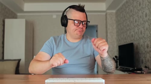 Man With Mohawk Using Keyboard at Home
