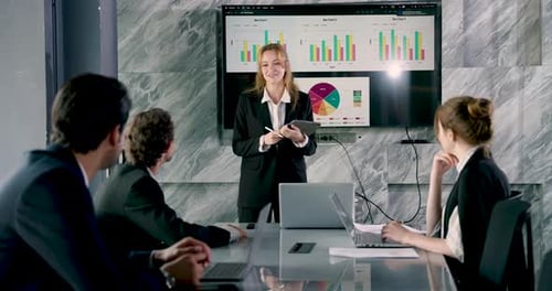 Young Woman Giving Business Presentation to Colleagues