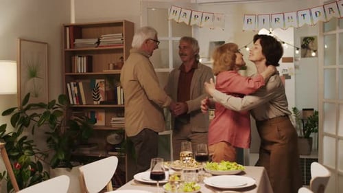 Friends Celebrating Birthday in Home Setting with Table