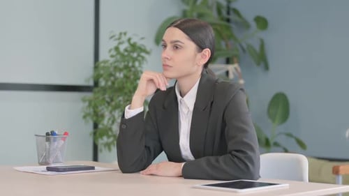 Thoughtful Young Businesswoman Thinking of New Idea