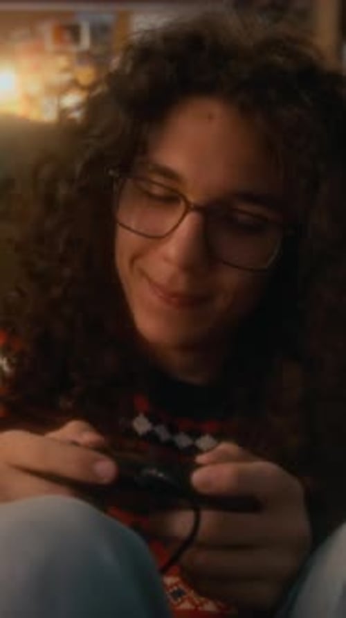 Vertical Slowmo of Boy Playing Video Game with Retro Controller in 90s