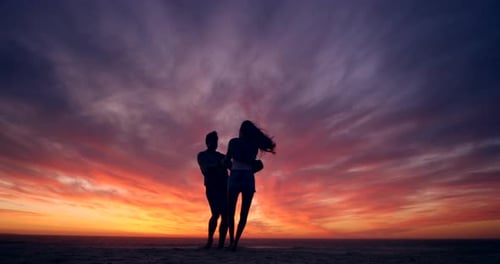 Silhouette, sunset and couple dance on the beach, love and happiness for romance