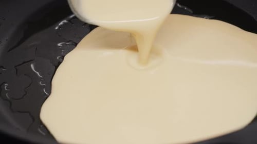 Crepes Preparation Closeup of Baking Thin Pancakes The Batter Falls Onto the Pan