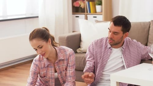 Affectionate couple shares pizza and wine at home