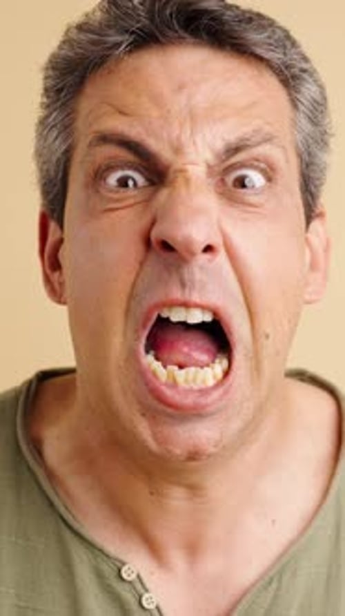 Man close-up yelling and appearing angry