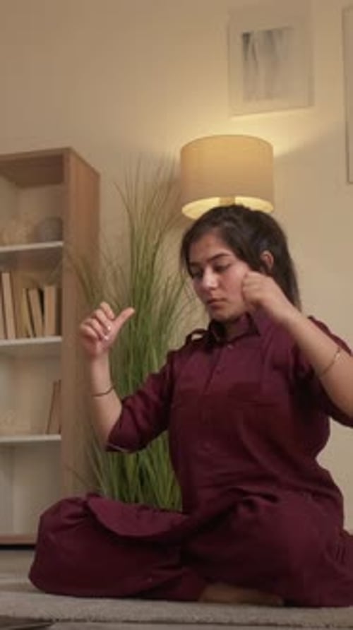 Woman Meditating and Practicing Hand Mudras Indoors