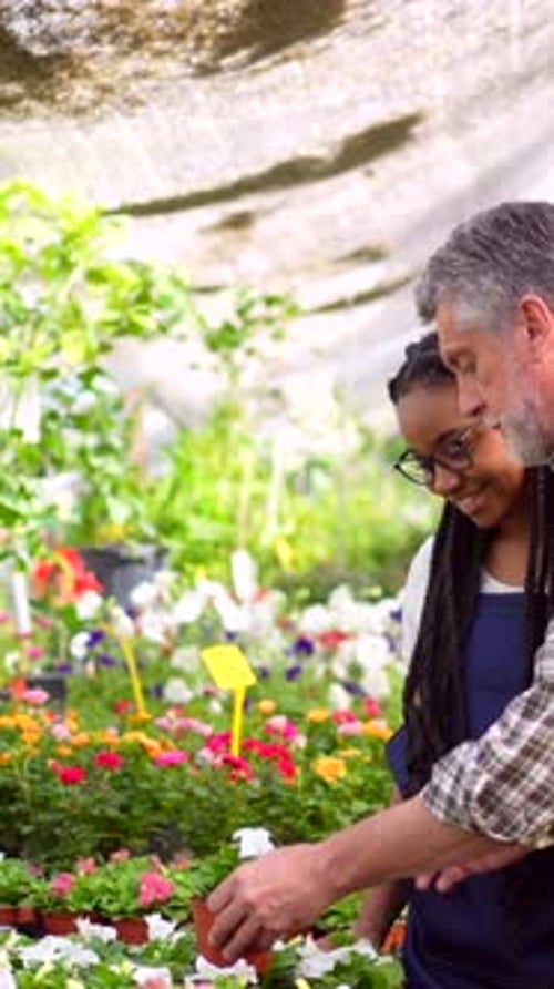 Young Woman Learning About Gardening With an Adult Man