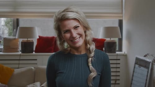 Blonde Woman Smiles Indoors