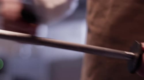 Chef Sharpening Knife With Honing Steel in Kitchen