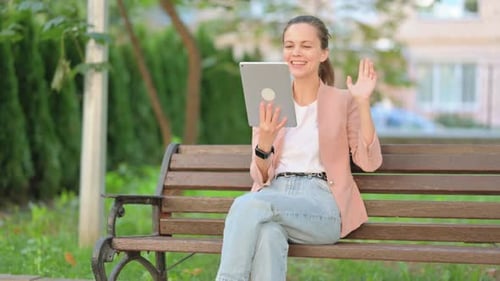 Casual Business Woman Doing Video Chat on Tablet Outdoor