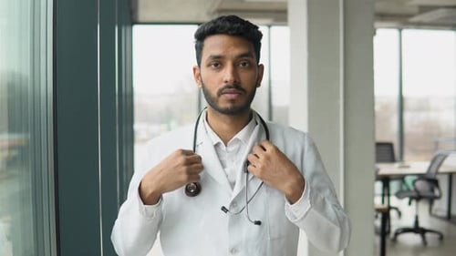 Indian or Pakistani Male Doctor Standing in Clinic