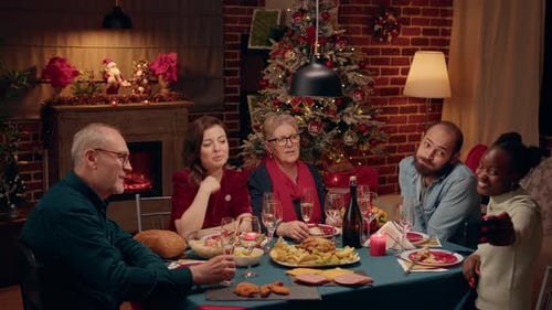 Family Celebrates Christmas With Dinner and Photographs