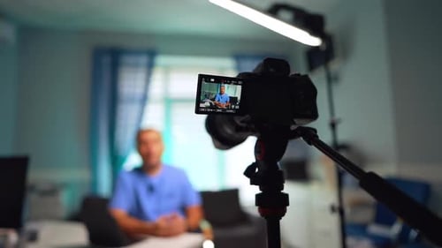 Man Recording Himself on Camera in Office