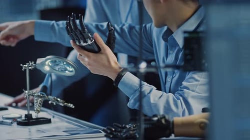 Technological Prosthetic Robot Arm is Tested by Two Professional Development Engineers in a High Te