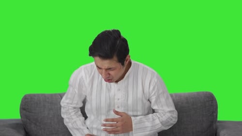 Sick Indian man having a cold and cough Green screen