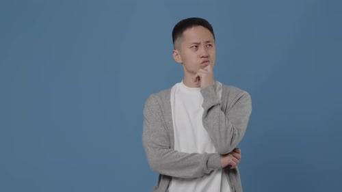 Young Adult Has Eureka Moment on Blue Background