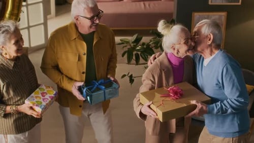 Happy Seniors Celebrate a Birthday with Gifts