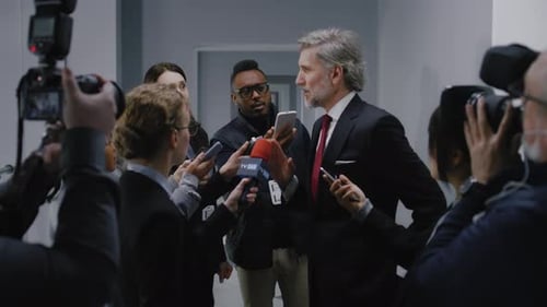 Man Interviewed by Press in Hallway