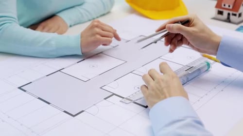Architects discuss blueprint for living house design project at home or office