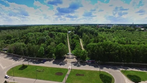 Large roundabout in the city near the green park. Two paths in the garden leading to the museum