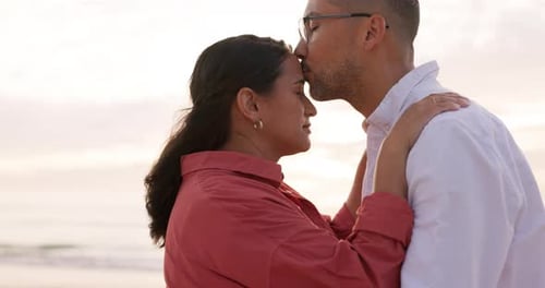 Love, kiss and sunset with couple at beach for romance, vacation and relax